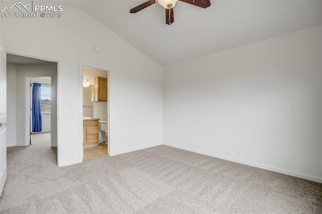 7689 Sniktau Pt, Peyton, CO 80831 - unfurnished bedroom with light carpet, lofted ceiling, baseboards, ceiling fan, and ensuite bath