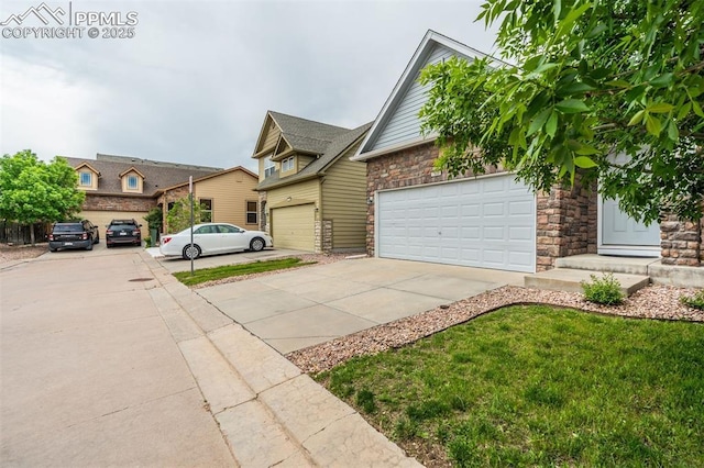 7689 Sniktau Pt, Peyton, CO 80831 - view of front facade featuring concrete driveway, stone siding, and a garage