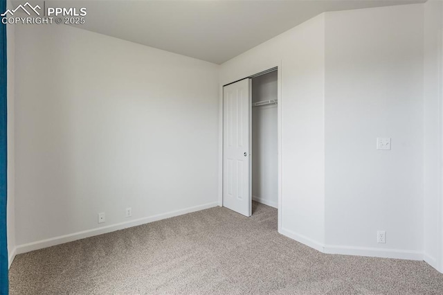 7689 Sniktau Pt, Peyton, CO 80831 - unfurnished bedroom with carpet flooring, baseboards, and a closet