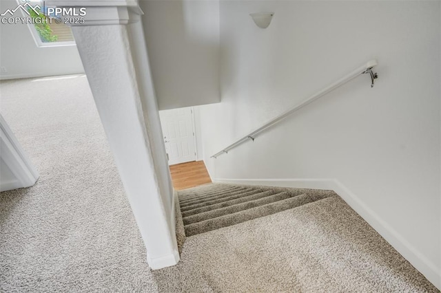 7689 Sniktau Pt, Peyton, CO 80831 - staircase with carpet floors and baseboards