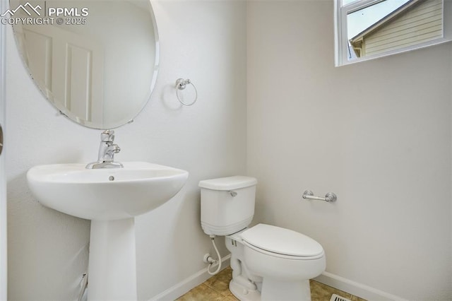 7689 Sniktau Pt, Peyton, CO 80831 - bathroom featuring baseboards, toilet, a sink, and tile patterned floors