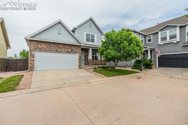 7689 Sniktau Pt, Peyton, CO 80831 - view of front facade featuring driveway, covered porch, and stone siding