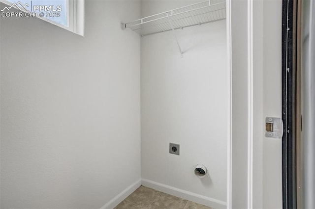 7689 Sniktau Pt, Peyton, CO 80831 - laundry room with electric dryer hookup, light tile patterned floors, and baseboards