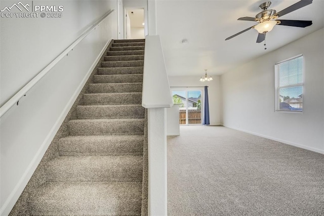 7689 Sniktau Pt, Peyton, CO 80831 - staircase featuring a chandelier, carpet flooring, a ceiling fan, and baseboards