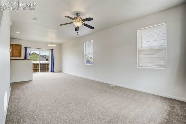 7689 Sniktau Pt, Peyton, CO 80831 - unfurnished living room featuring a chandelier, carpet flooring, ceiling fan, and baseboards