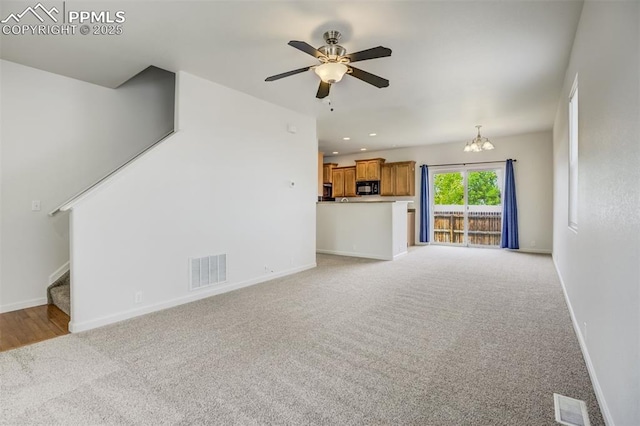 7689 Sniktau Pt, Peyton, CO 80831 - unfurnished living room featuring light carpet, stairway, ceiling fan, and baseboards