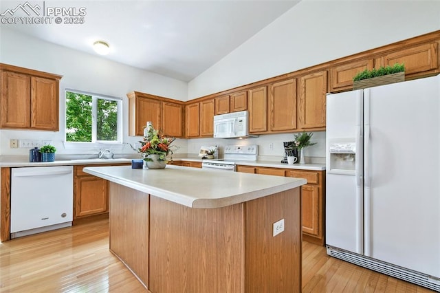 1646 Pinon Glen Cir, Colorado Springs, CO 80919 - kitchen featuring white appliances, light countertops, brown cabinetry, light wood finished floors, and high vaulted ceiling