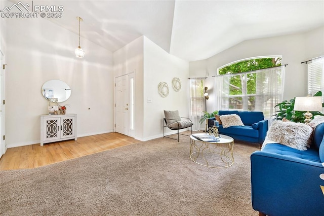 1646 Pinon Glen Cir, Colorado Springs, CO 80919 - carpeted living room with vaulted ceiling, wood finished floors, and baseboards