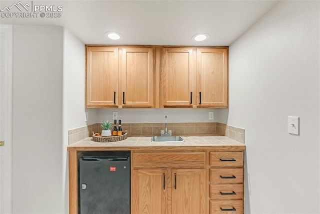 10467 Pictured Rocks Dr, Peyton, CO 80831 - kitchen featuring tile counters, a sink, fridge, light brown cabinetry, and recessed lighting