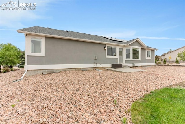 10467 Pictured Rocks Dr, Peyton, CO 80831 - rear view of house featuring roof mounted solar panels and a patio area