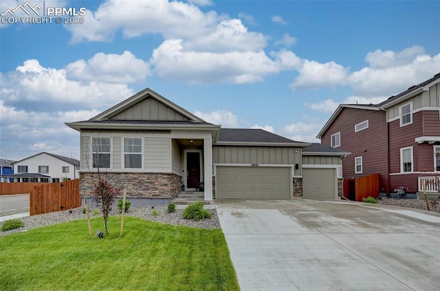 10806 Rolling Peaks Dr, Peyton, CO 80831 - view of front of house featuring board and batten siding, stone siding, a garage, and concrete driveway