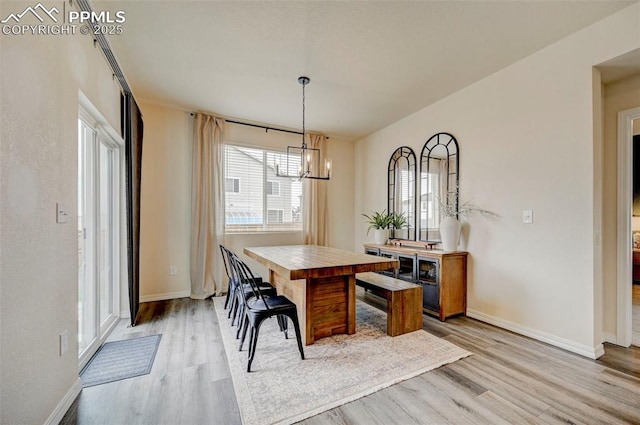 10806 Rolling Peaks Dr, Peyton, CO 80831 - dining space featuring light wood finished floors, a chandelier, and baseboards
