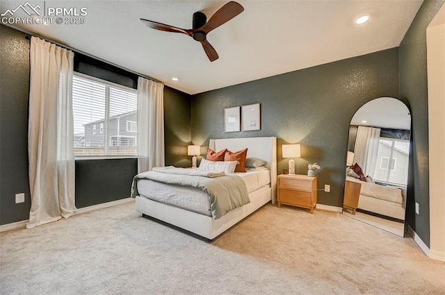 10806 Rolling Peaks Dr, Peyton, CO 80831 - carpeted bedroom with baseboards, ceiling fan, recessed lighting, arched walkways, and a textured wall