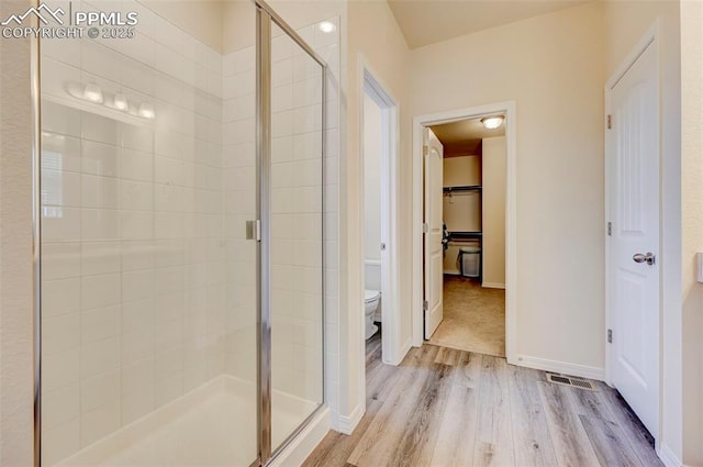 10806 Rolling Peaks Dr, Peyton, CO 80831 - full bathroom featuring toilet, wood finished floors, a shower stall, and baseboards