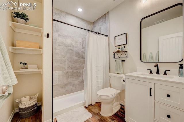 10806 Rolling Peaks Dr, Peyton, CO 80831 - bathroom featuring wood finished floors, toilet, vanity, and a tile shower
