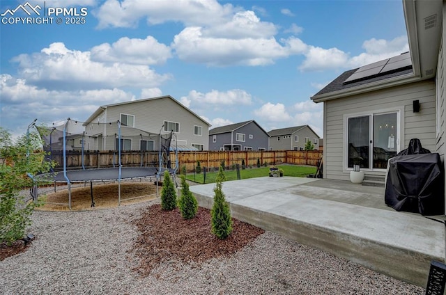 10806 Rolling Peaks Dr, Peyton, CO 80831 - view of patio / terrace with a trampoline and a residential view