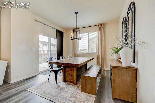 10806 Rolling Peaks Dr, Peyton, CO 80831 - dining room featuring a chandelier, wood finished floors, and baseboards