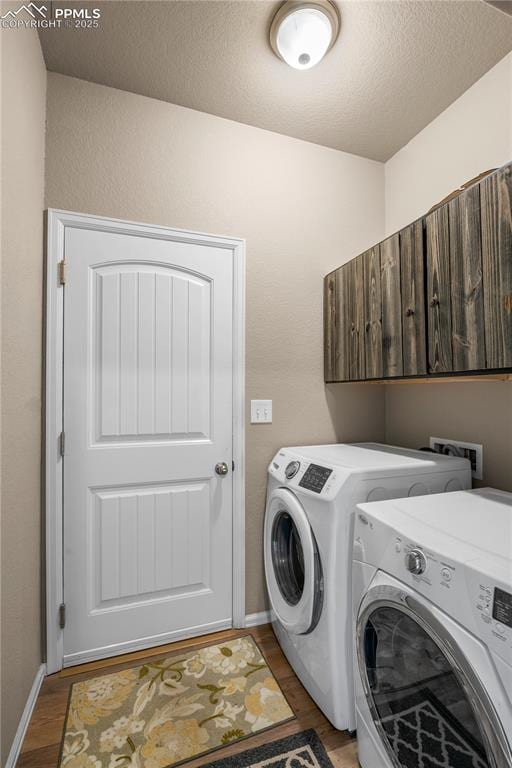 5228 Gannet Ln, Pueblo, CO 81008 - laundry area with separate washer and dryer, wood finished floors, cabinet space, and a textured ceiling