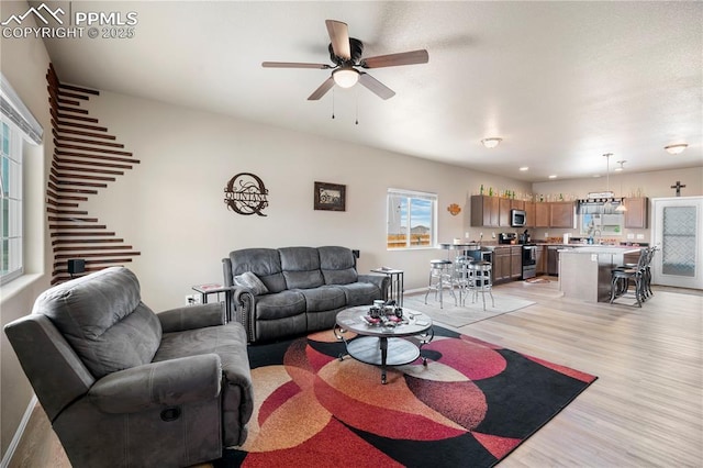 5228 Gannet Ln, Pueblo, CO 81008 - living area featuring light wood-type flooring and ceiling fan