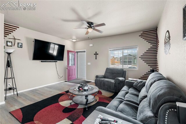 5228 Gannet Ln, Pueblo, CO 81008 - living room featuring a ceiling fan, light wood-style floors, and stairs