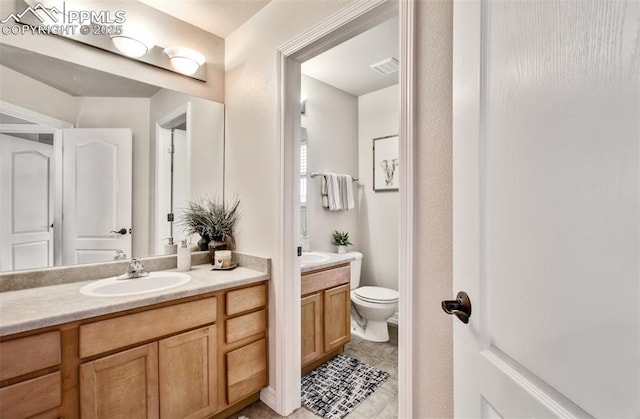 2582 Indian Hills Grv, Colorado Springs, CO 80907 - bathroom with vanity, toilet, and tile patterned flooring