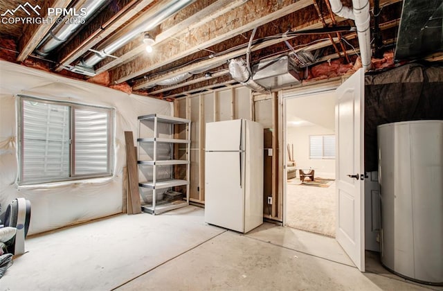 2582 Indian Hills Grv, Colorado Springs, CO 80907 - unfinished basement featuring freestanding refrigerator and water heater
