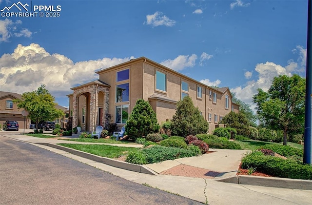 2582 Indian Hills Grv, Colorado Springs, CO 80907 - view of property featuring stucco siding and a residential view