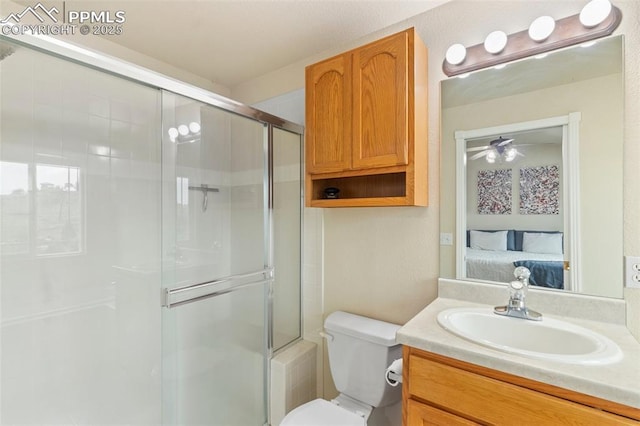 2237 Stepping Stones Way Unit C, Colorado Springs, CO 80904 - full bath with connected bathroom, a shower with door, toilet, vanity, and ceiling fan