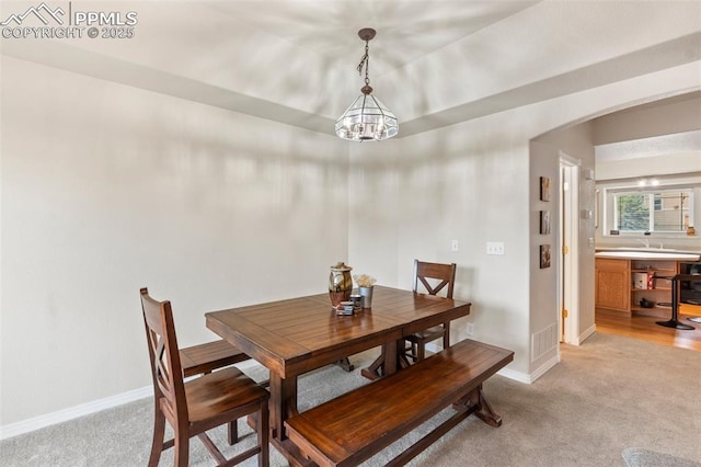 2237 Stepping Stones Way Unit C, Colorado Springs, CO 80904 - dining room with light colored carpet, a chandelier, baseboards, and arched walkways