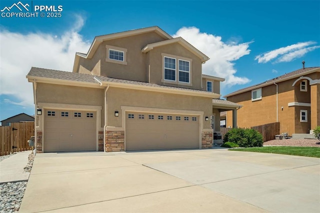 10208 Abrams Dr, Colorado Springs, CO 80925 - view of front of property with stucco siding, driveway, stone siding, and an attached garage