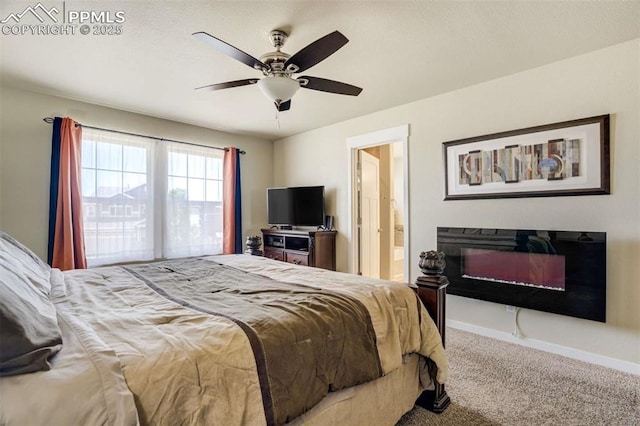 10208 Abrams Dr, Colorado Springs, CO 80925 - carpeted bedroom with a glass covered fireplace, a ceiling fan, and ensuite bathroom