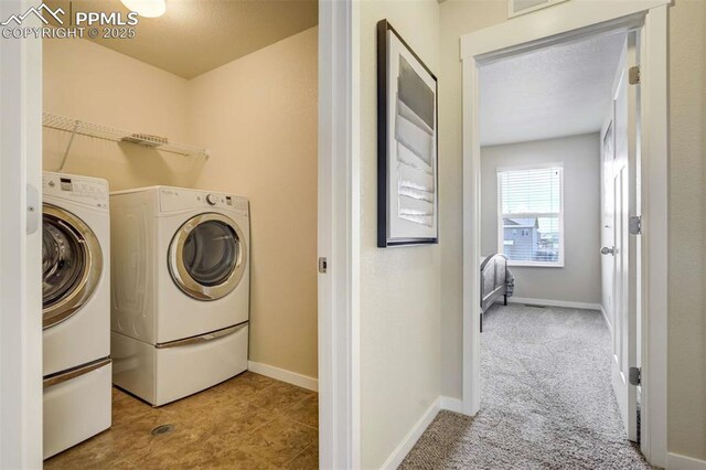 10208 Abrams Dr, Colorado Springs, CO 80925 - washroom with washing machine and clothes dryer and carpet floors