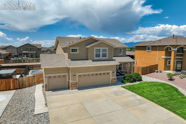 10208 Abrams Dr, Colorado Springs, CO 80925 - view of front of home featuring stucco siding, concrete driveway, a garage, stone siding, and a residential view