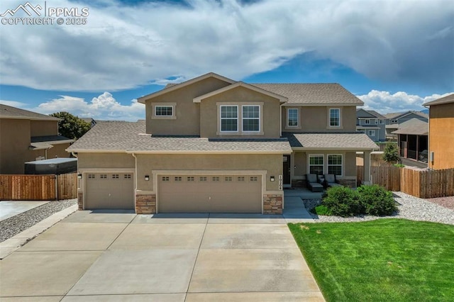 10208 Abrams Dr, Colorado Springs, CO 80925 - view of front of property with stucco siding, stone siding, driveway, and an attached garage