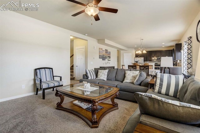 10208 Abrams Dr, Colorado Springs, CO 80925 - living area with stairs, a chandelier, a ceiling fan, and light colored carpet