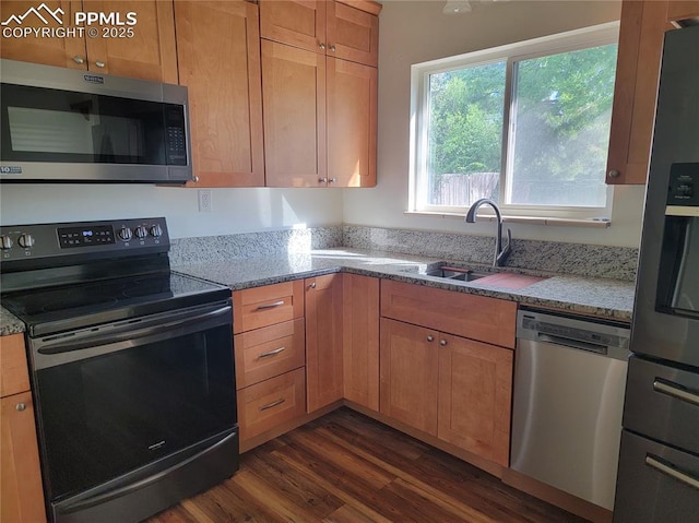 2619 N Arcadia St, Colorado Springs, CO 80907 - kitchen featuring appliances with stainless steel finishes, dark wood-style flooring, a sink, and light stone counters