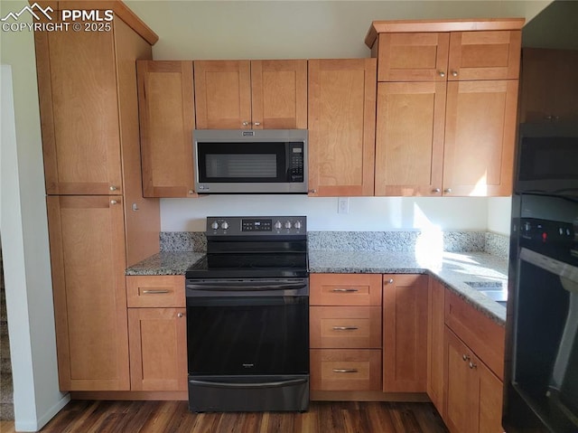 2619 N Arcadia St, Colorado Springs, CO 80907 - kitchen with black appliances, dark wood-type flooring, and light stone countertops