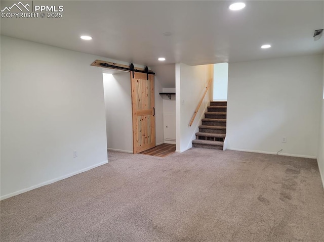 2619 N Arcadia St, Colorado Springs, CO 80907 - finished below grade area with a barn door, carpet flooring, recessed lighting, stairs, and baseboards