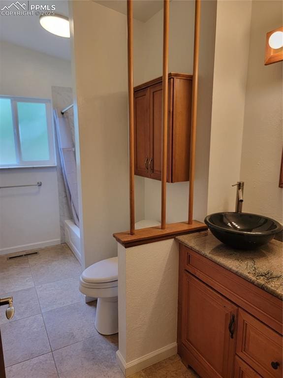 2619 N Arcadia St, Colorado Springs, CO 80907 - full bathroom featuring toilet, vanity, shower / bathtub combination with curtain, tile patterned flooring, and baseboards