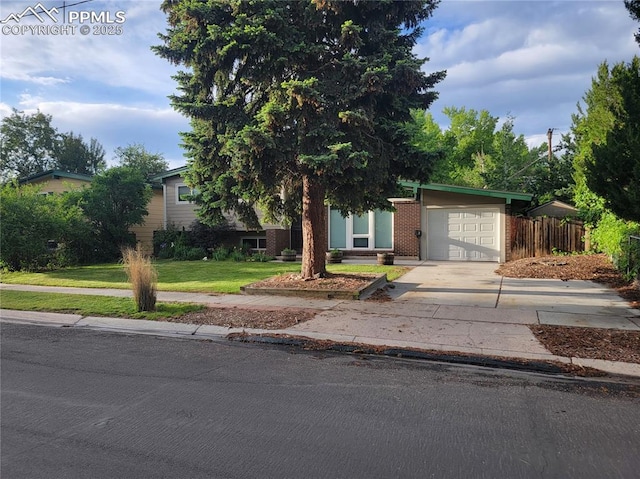 2619 N Arcadia St, Colorado Springs, CO 80907 - view of property hidden behind natural elements with an attached garage and concrete driveway