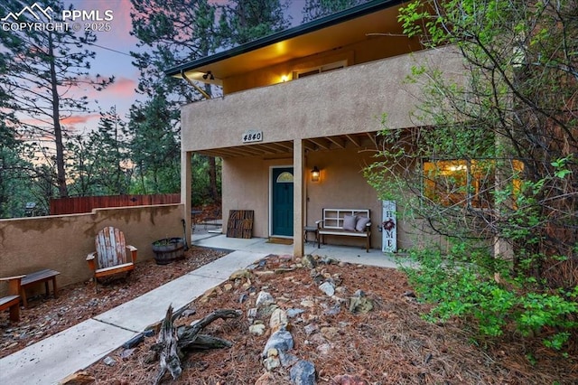 4840 Pikes Peak Hwy, Cascade, CO 80809 - back of property at dusk featuring stucco siding and a patio