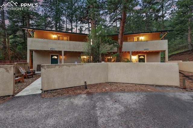 4840 Pikes Peak Hwy, Cascade, CO 80809 - modern home featuring a fenced front yard and stucco siding