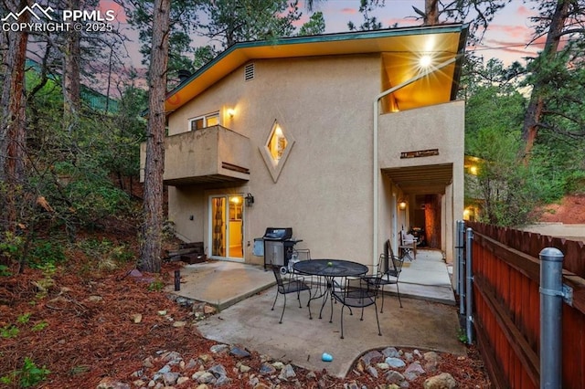 4840 Pikes Peak Hwy, Cascade, CO 80809 - rear view of house with a balcony, stucco siding, and a patio