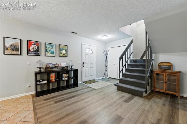 4840 Pikes Peak Hwy, Cascade, CO 80809 - entryway with wood finished floors, stairway, a textured ceiling, and baseboards