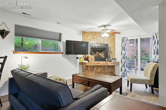 4840 Pikes Peak Hwy, Cascade, CO 80809 - living area with wood finished floors, a ceiling fan, and a textured ceiling