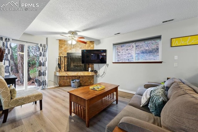 4840 Pikes Peak Hwy, Cascade, CO 80809 - living area with a textured ceiling, ceiling fan, baseboards, and wood finished floors