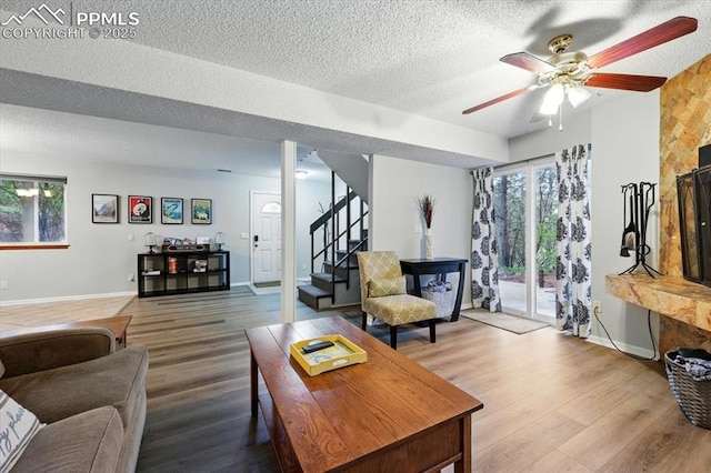 4840 Pikes Peak Hwy, Cascade, CO 80809 - living room featuring stairway, wood finished floors, a ceiling fan, a textured ceiling, and baseboards