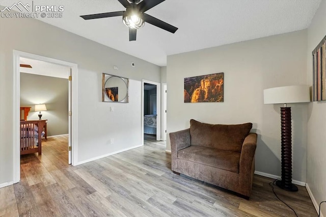 4840 Pikes Peak Hwy, Cascade, CO 80809 - living area featuring light wood-style flooring, a ceiling fan, and baseboards