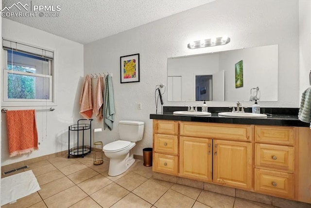 4840 Pikes Peak Hwy, Cascade, CO 80809 - full bathroom featuring a textured ceiling, a textured wall, double vanity, toilet, and tile patterned flooring