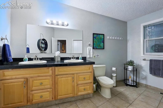 4840 Pikes Peak Hwy, Cascade, CO 80809 - full bath with double vanity, a textured ceiling, toilet, and tile patterned floors